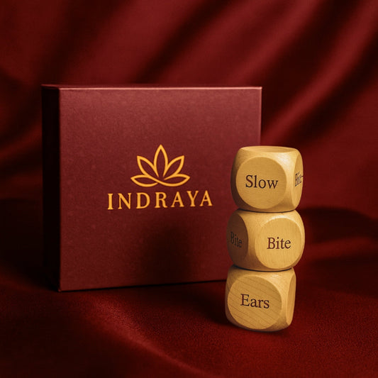 Wooden dice with text 'Slow', 'Bite', 'Ears' stacked in front of an Indraya branded box on a red fabric background.